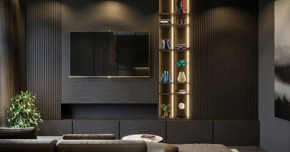 Dark, modern living room with a wall-mounted smart TV, softly lit shelves and a sofa in the foreground
